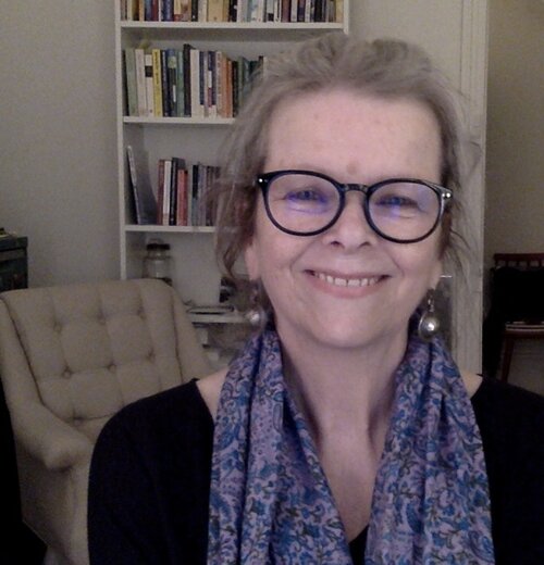 Lesley Porter smiles at the camera, wearing a patterned scarf.