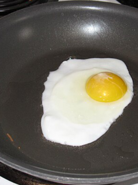 A photo of an egg on a frypan.